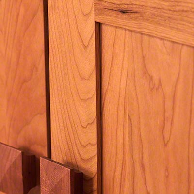 A close up of a wooden cabinet door.