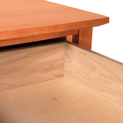 A wooden desk with a drawer.