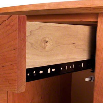 A drawer in a wooden cabinet.