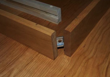 A wooden drawer with a piece of wood in it.