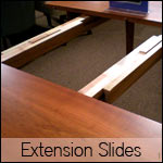 An image of a table with extension slides.