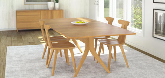 A wooden dining table and chairs in a room.