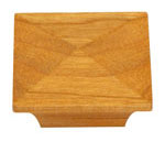 A square wooden knob on a white background.