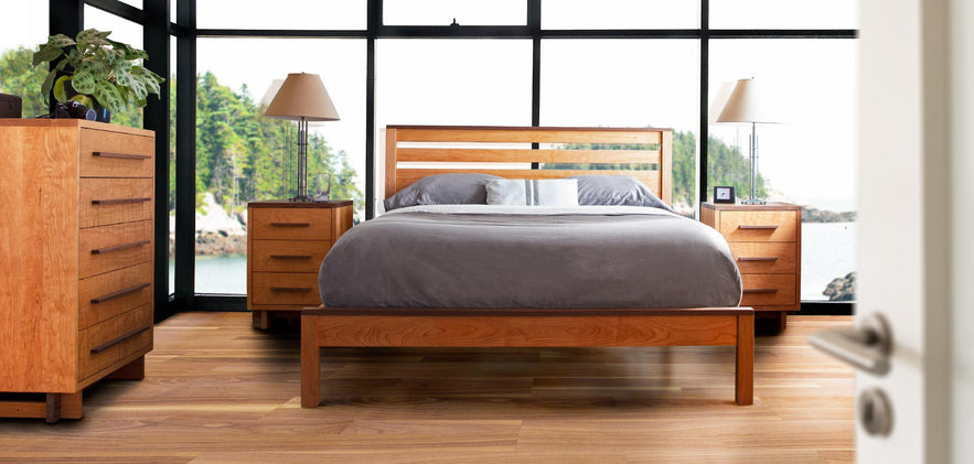 A bedroom with a wooden bed and dresser.