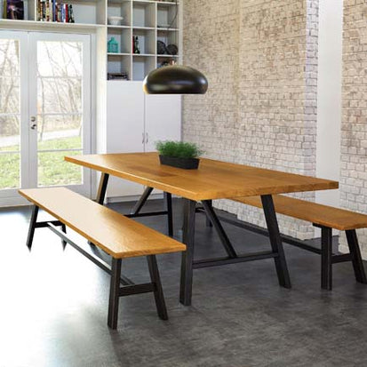 A wooden table and two benches in a room.