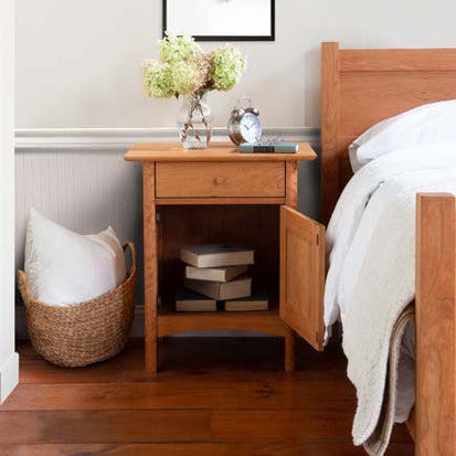 A bed with a nightstand next to it.