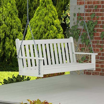 A white porch swing on a porch.