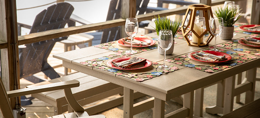 A table with chairs and a view of the ocean.