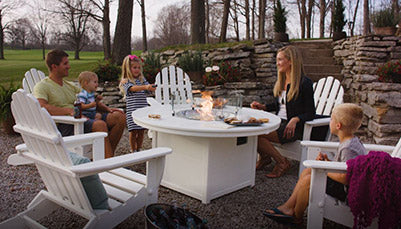 HDPE recycled plastic outdoor adirondack furniture. Made in the USA by Polywood. Set includes 5 adirondack chairs and a propane fire pit. Shown in white.