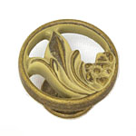A brass cabinet knob with a floral design.