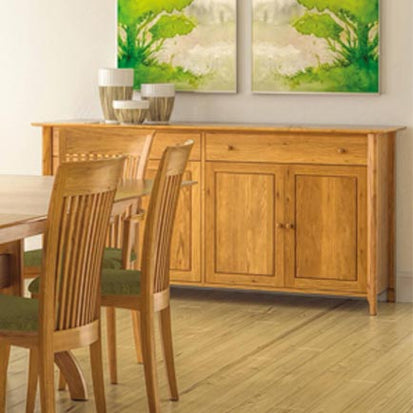 A dining room with a wooden table and chairs.