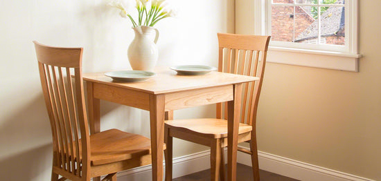A small table and chairs in a small room.