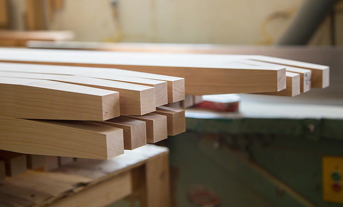 A stack of wooden boards on a workbench.