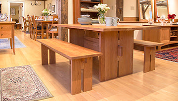 Elegant wooden dining table with matching benches showcasing craftsmanship and quality.