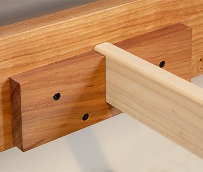A close up of a piece of wood with holes in it.