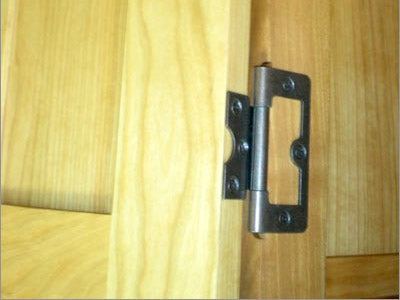A close up of a wooden cabinet door.