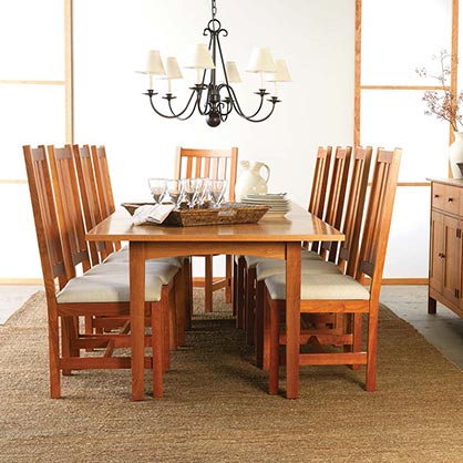 A dining room with a wooden table and chairs.
