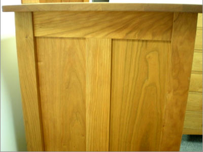 A wooden dresser with a wooden top.