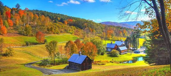 High-quality American-made wooden furniture showcased against a rural autumn landscape backdrop.