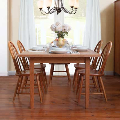 A dining room with a wooden table and chairs.