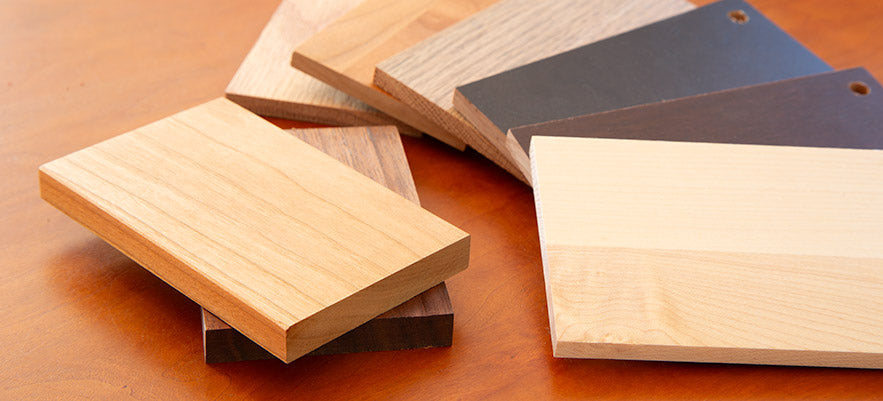 A variety of wood veneers on a wooden table.