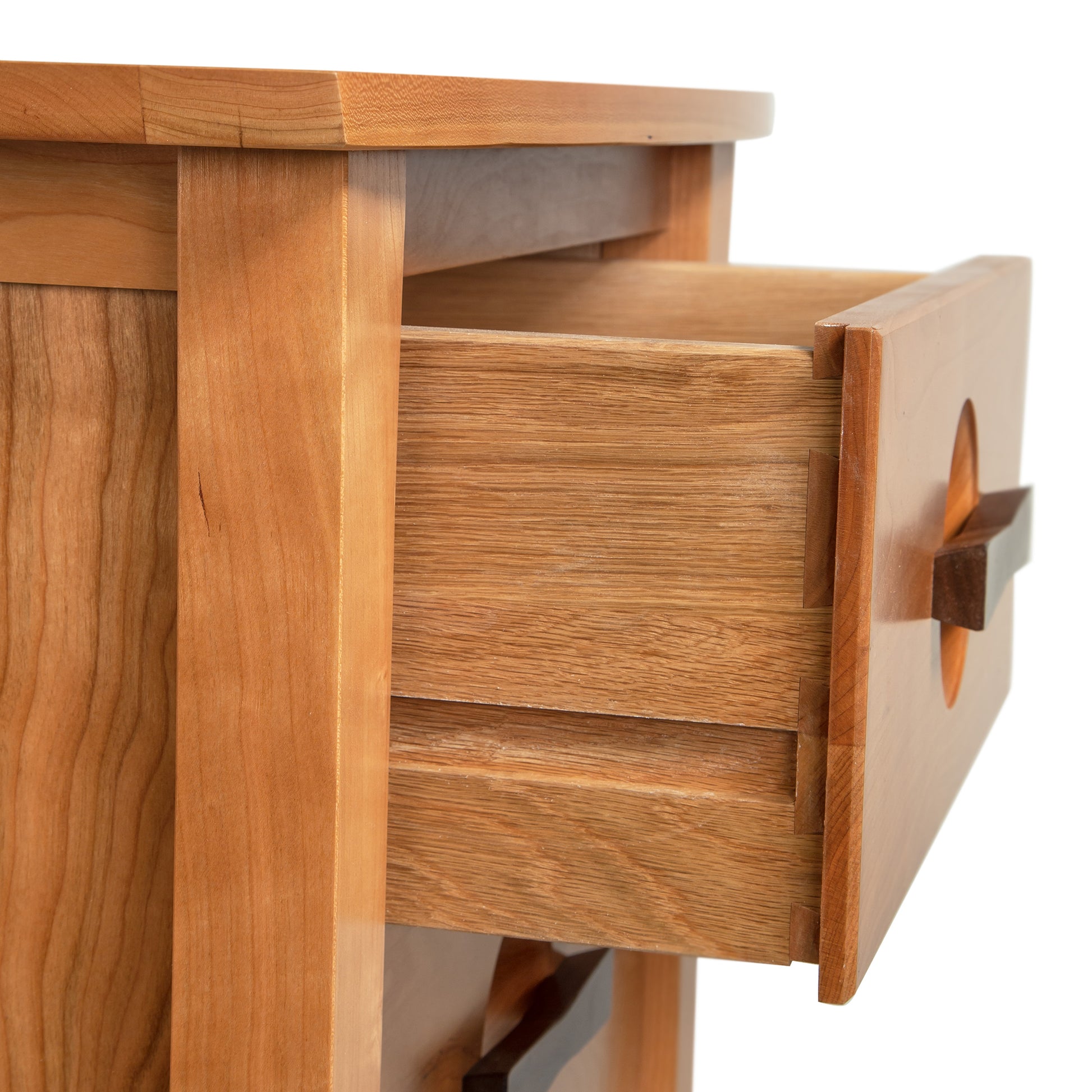 A close up of a wooden nightstand with drawers.