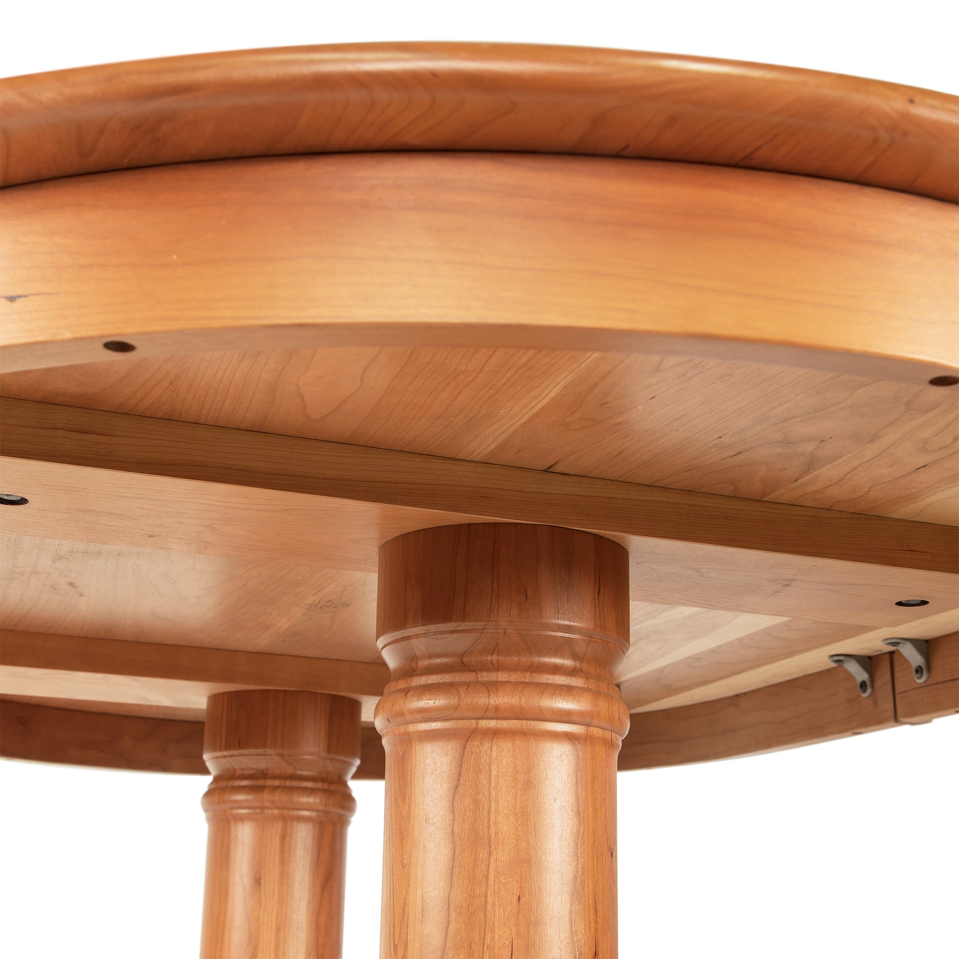 The top of a wooden table with two legs.