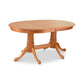 A wooden oval dining table with four legs.