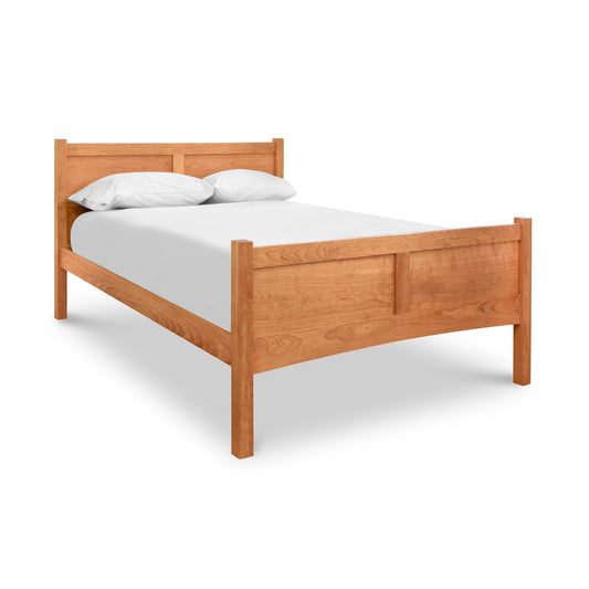 A wooden bed with a white sheet on it.