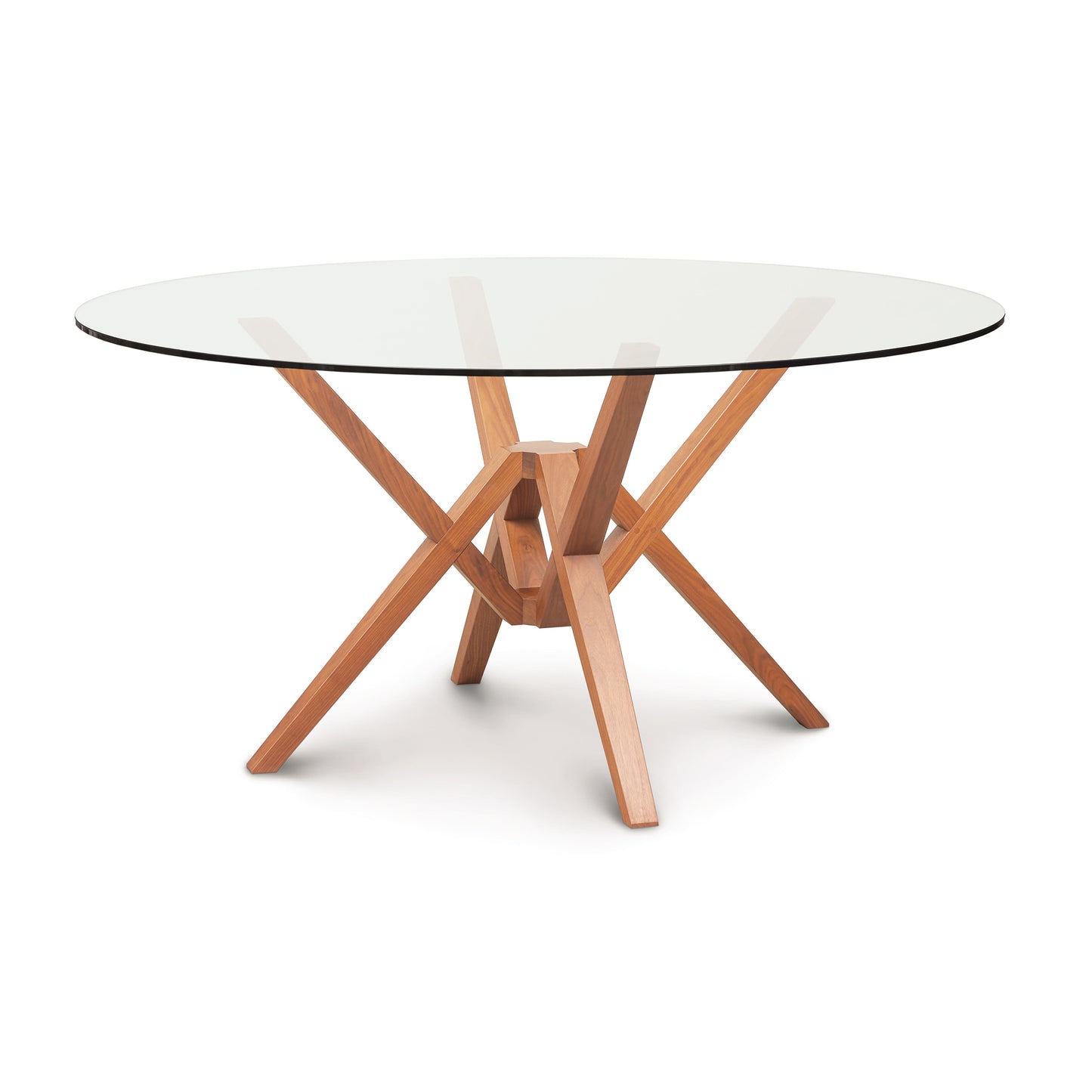 A round dining table with wooden legs and a glass top.