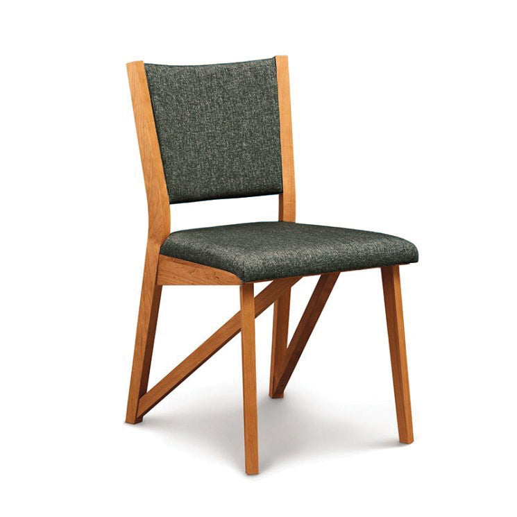 A wooden chair with a grey upholstered seat.