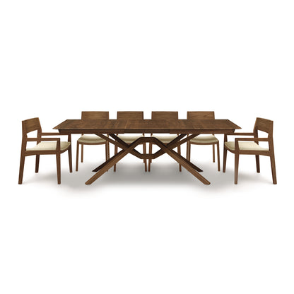 A wooden dining table with six chairs.