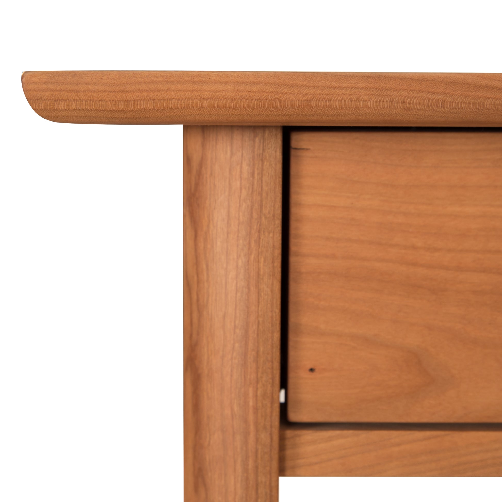 A close up of a wooden table with a drawer.