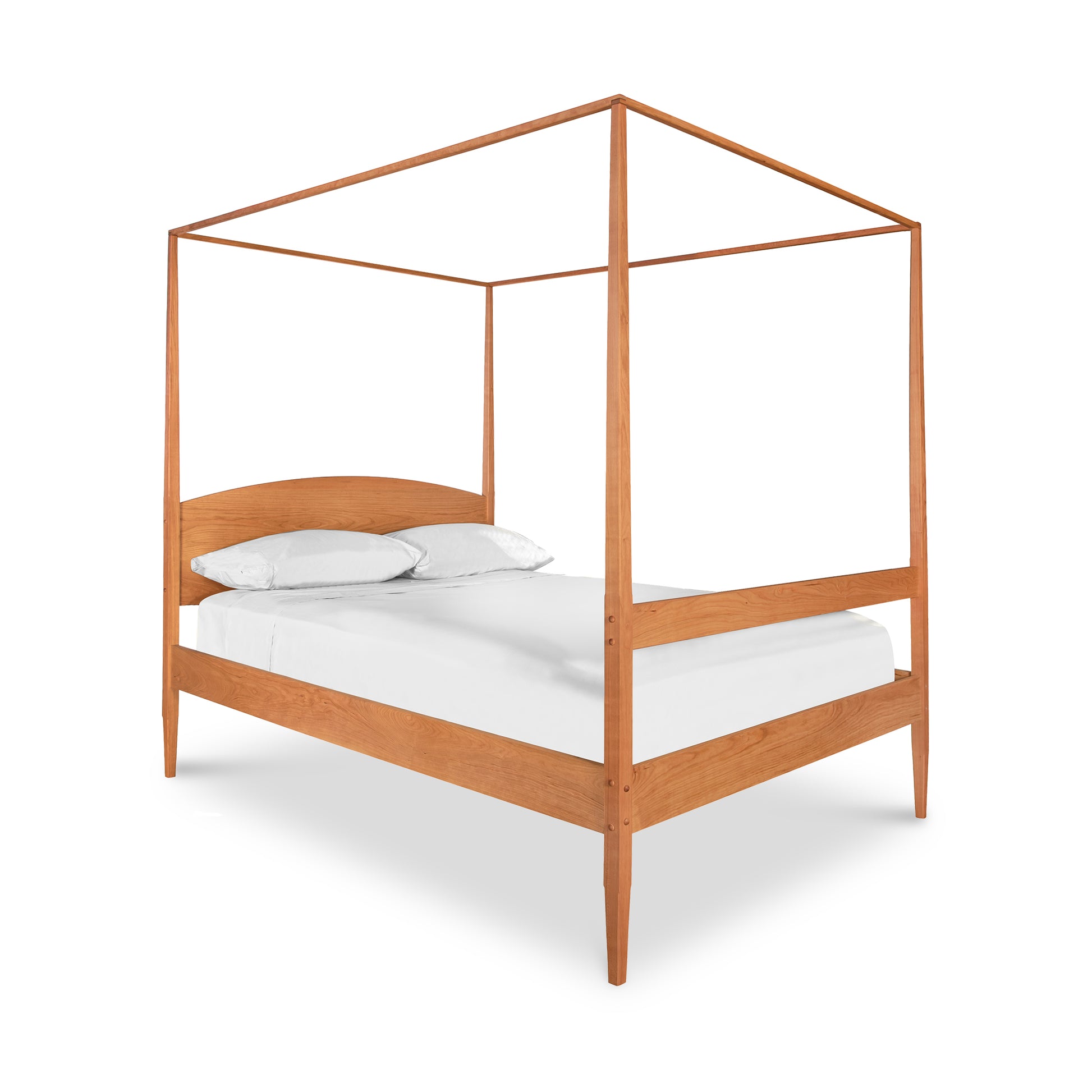 A wooden canopy bed with white sheets on it.