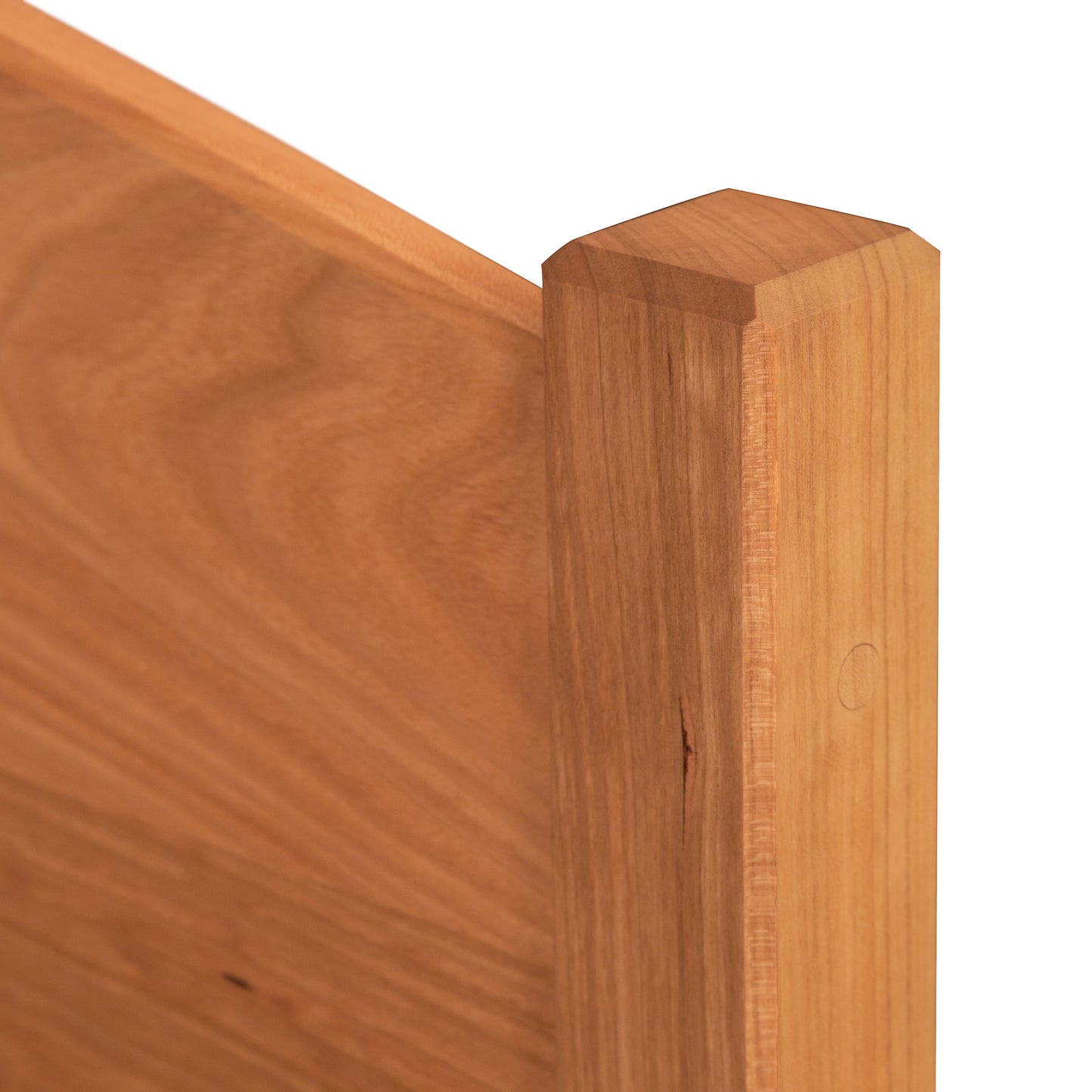 A close up of a wooden bed frame.