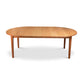 A wooden dining table with an oval shape.