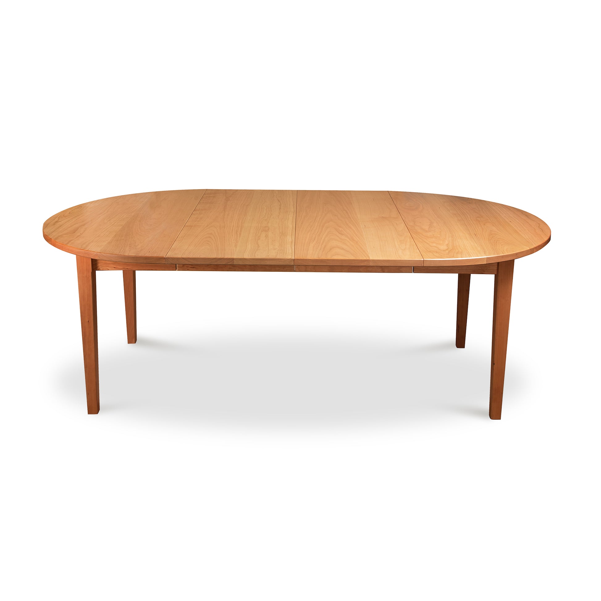 A wooden dining table with an oval shape.
