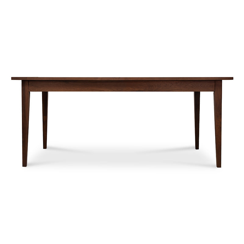 A wooden dining table with a dark brown finish.